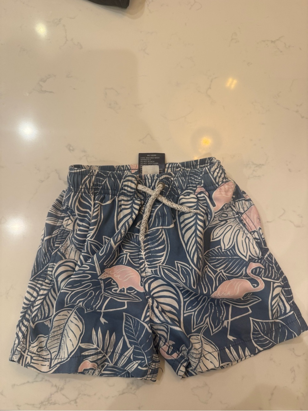 surf style youth Blue and White Tropical Print Swim Shorts. Size 5-6